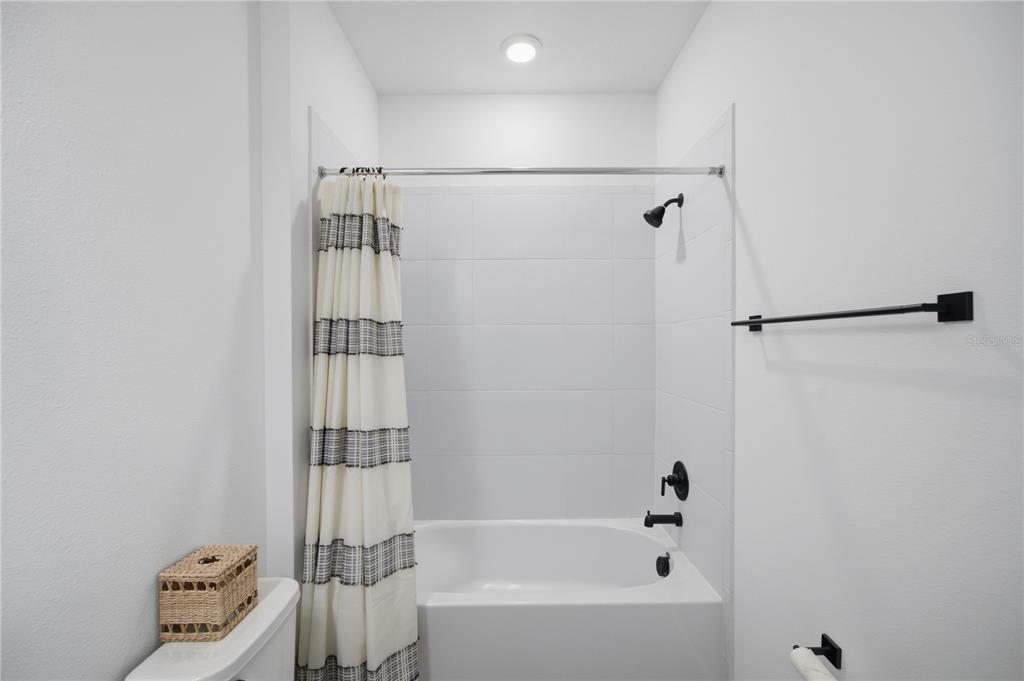 13816 Sharp Hawk Drive Riverview, FL 33569 - Photo 47 of 76 a bathroom with a bathtub and a shower