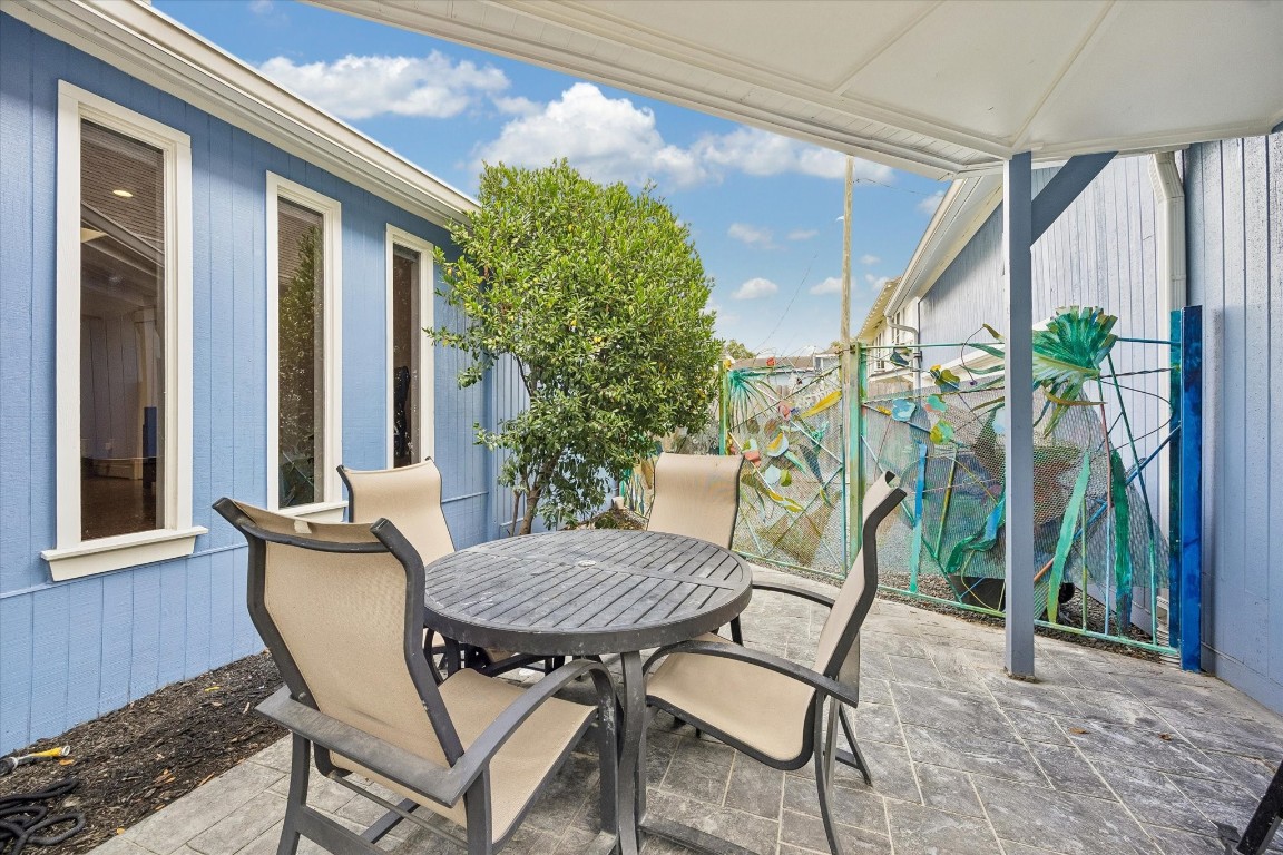 1307 Marshall Street Houston, TX 77006 - Photo 20 of 23 Cozy sitting area by the pool features a fence that is truly a work of art by artist Gertrude Barnstone.