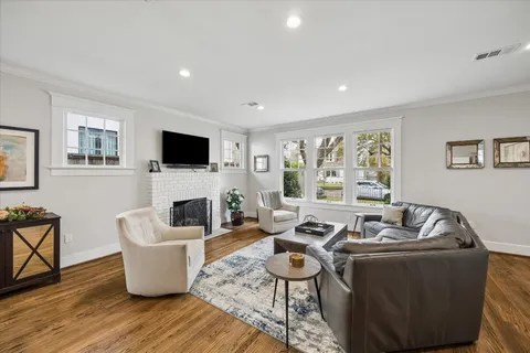 a dining room with furniture a window and wooden floor