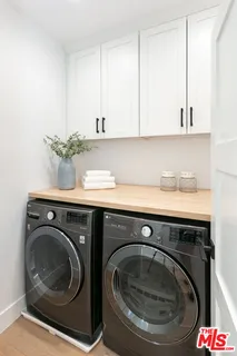 a utility room with sink dryer and washer