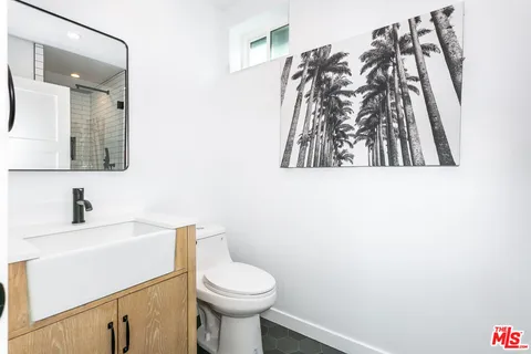 a bathroom with a toilet sink and vanity