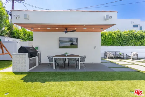 a view of a patio with table and chairs potted plants with wooden floor
