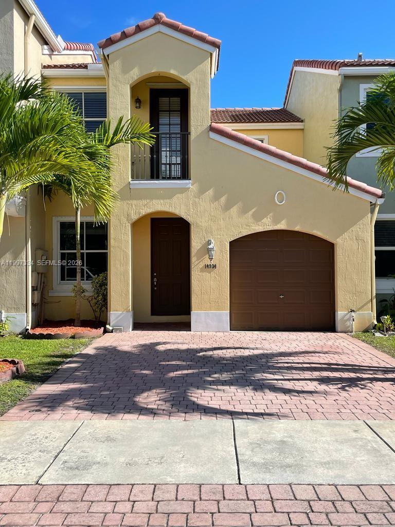 a front view of a house with yard