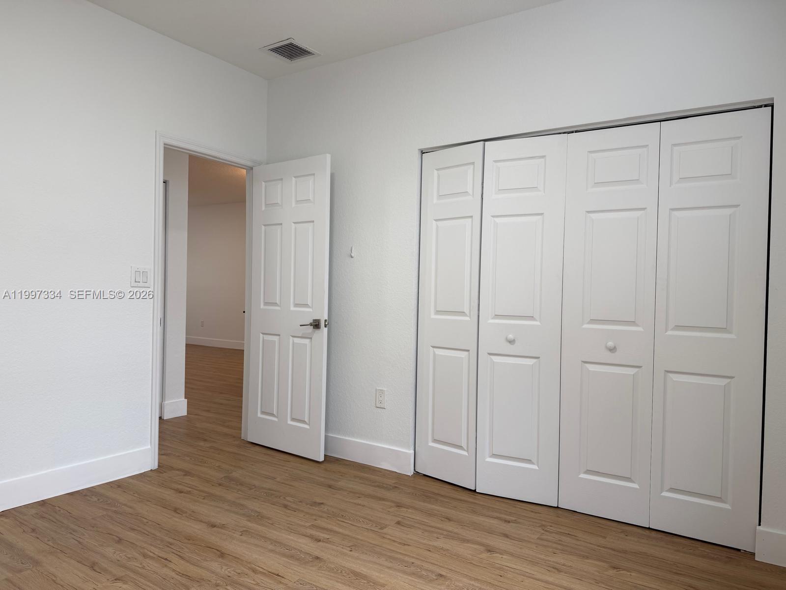 14934 Southwest 41st Lane, Unit 14934 Miami, FL 33185 - Photo 11 of 36 a view of an empty room with wooden floor