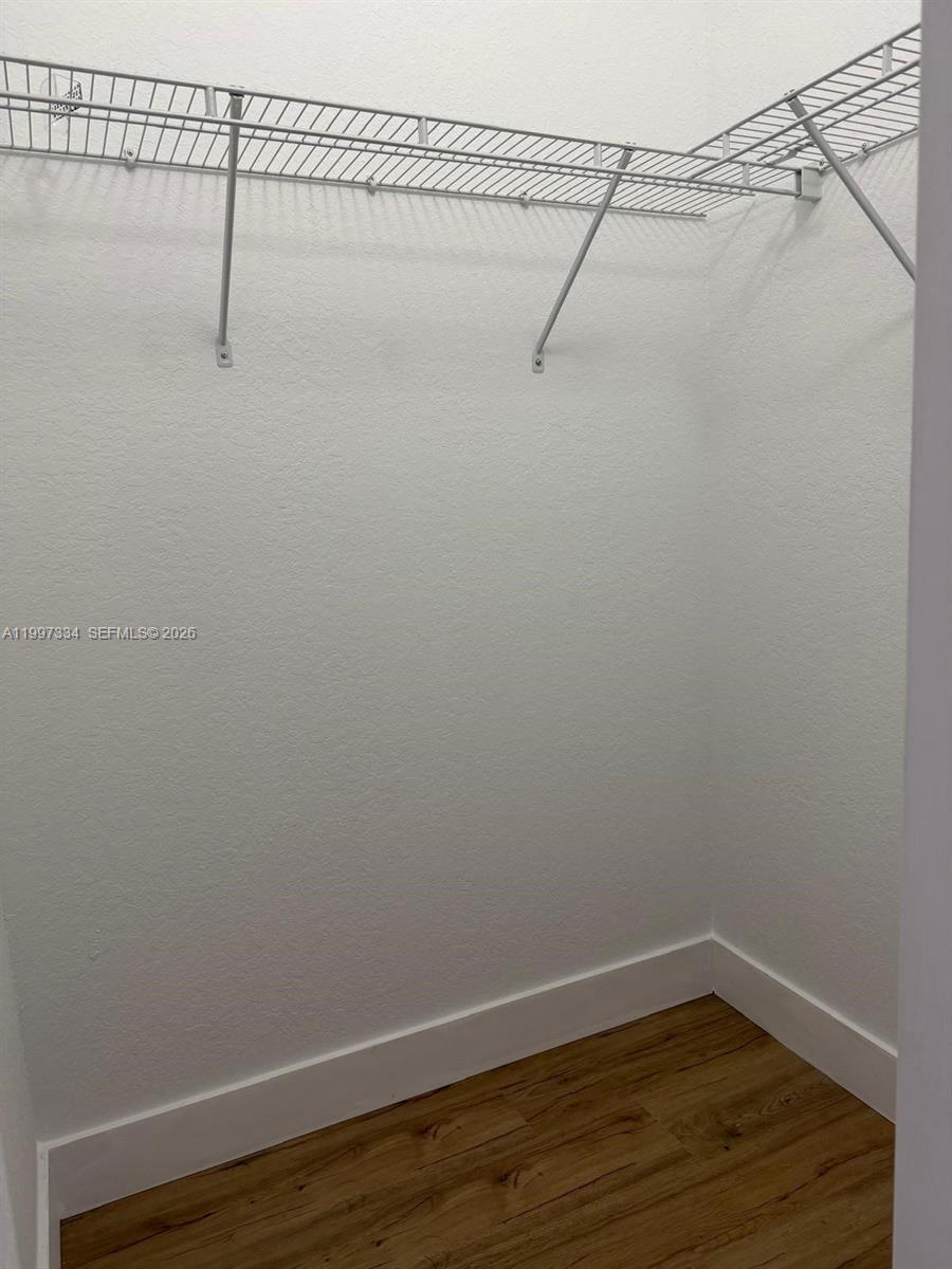 14934 Southwest 41st Lane, Unit 14934 Miami, FL 33185 - Photo 20 of 36 a view of a room with racks on the wall