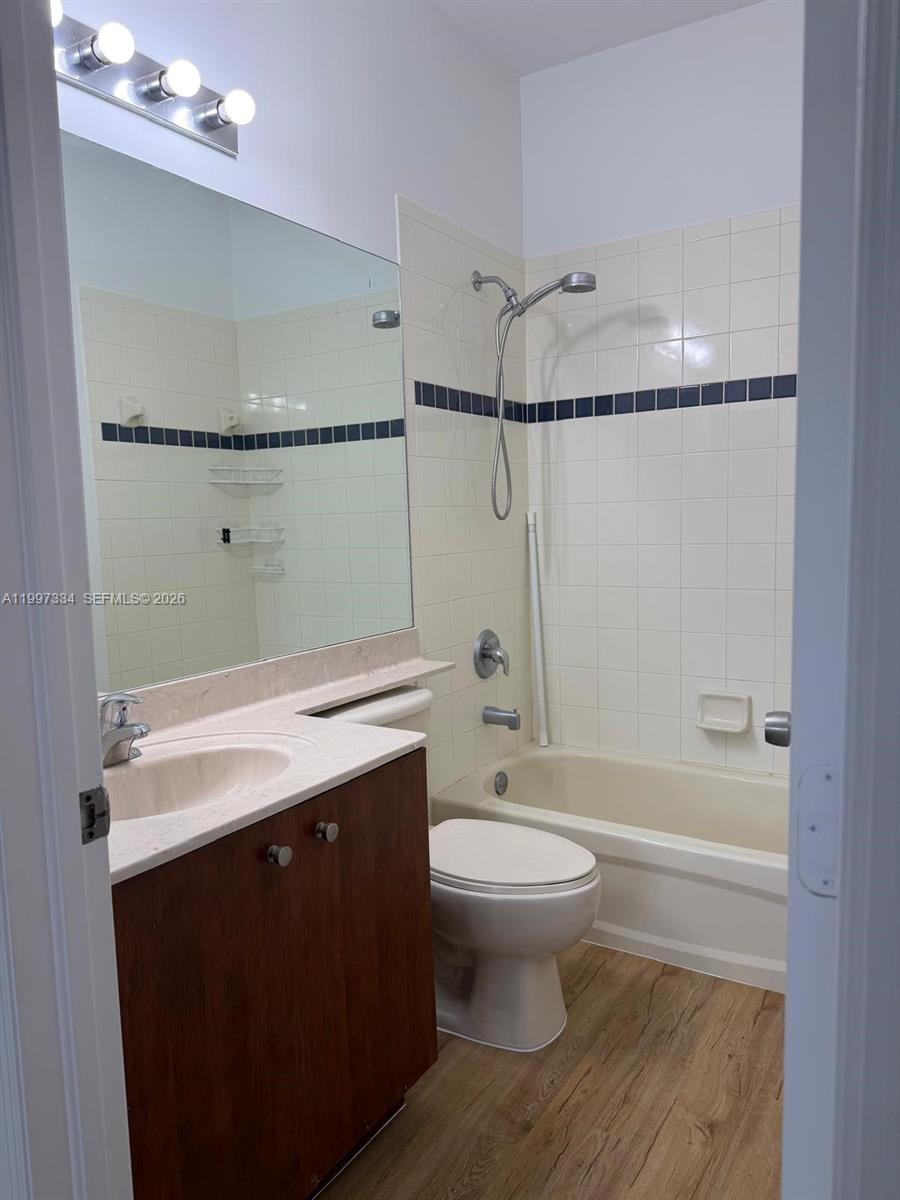 14934 Southwest 41st Lane, Unit 14934 Miami, FL 33185 - Photo 21 of 36 a bathroom with a sink a toilet a mirror and shower