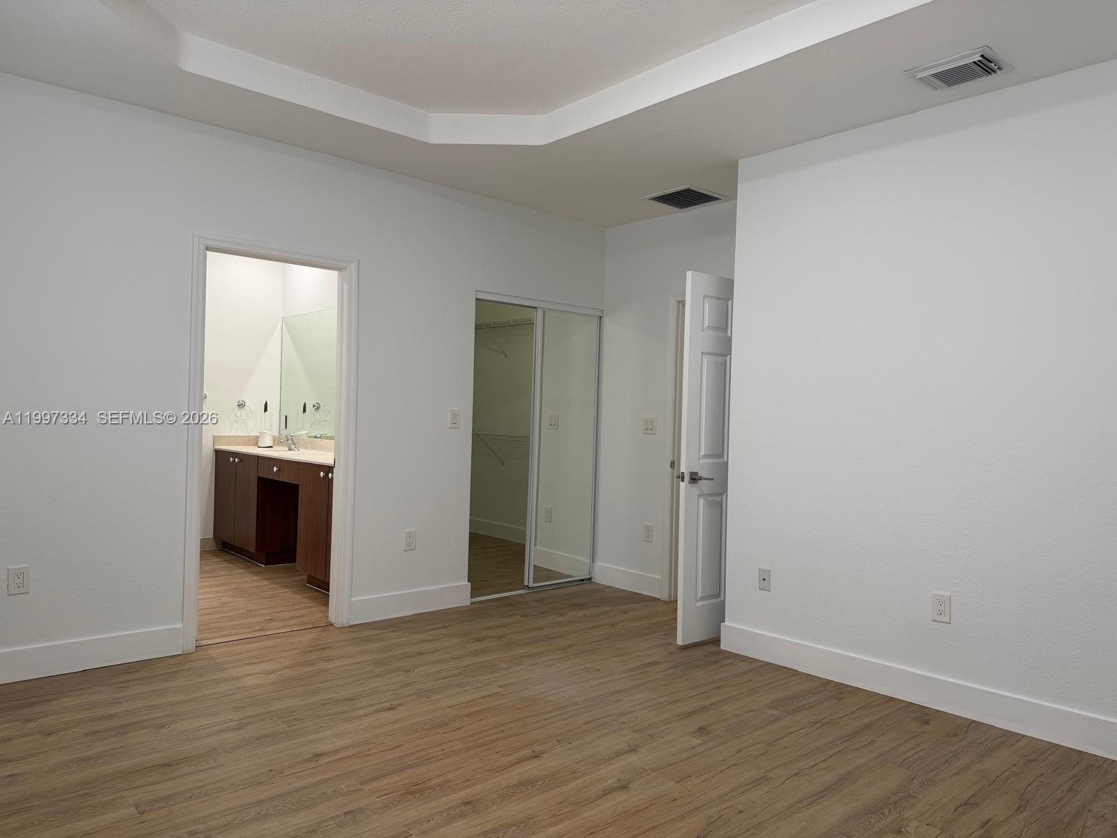 14934 Southwest 41st Lane, Unit 14934 Miami, FL 33185 - Photo 26 of 36 an empty room with wooden floor and windows