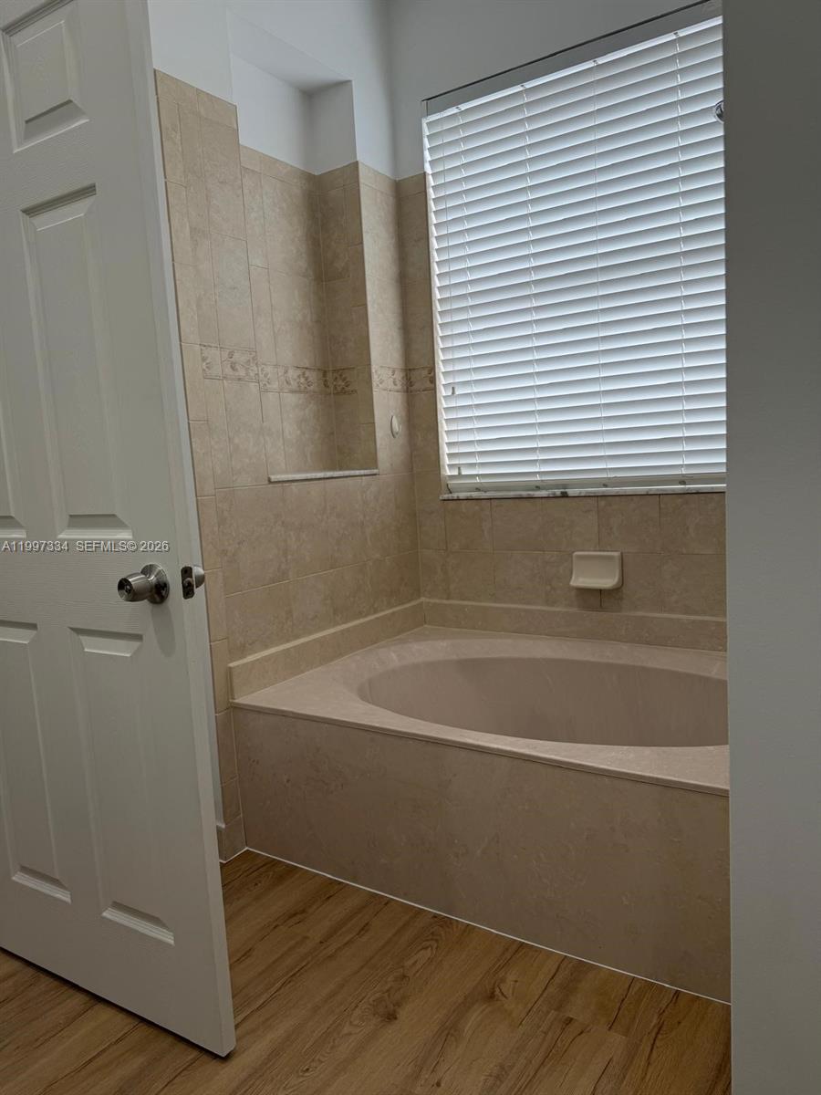 14934 Southwest 41st Lane, Unit 14934 Miami, FL 33185 - Photo 31 of 36 a bathroom with a bathtub