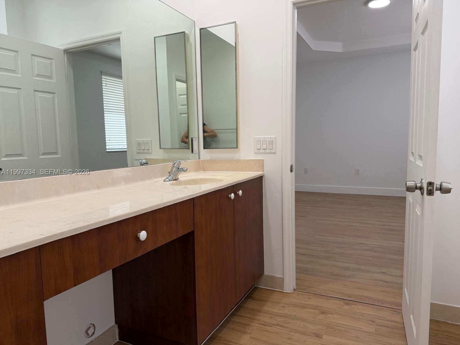 14934 Southwest 41st Lane, Unit 14934 Miami, FL 33185 - Photo 32 of 36 a bathroom with a sink and a mirror