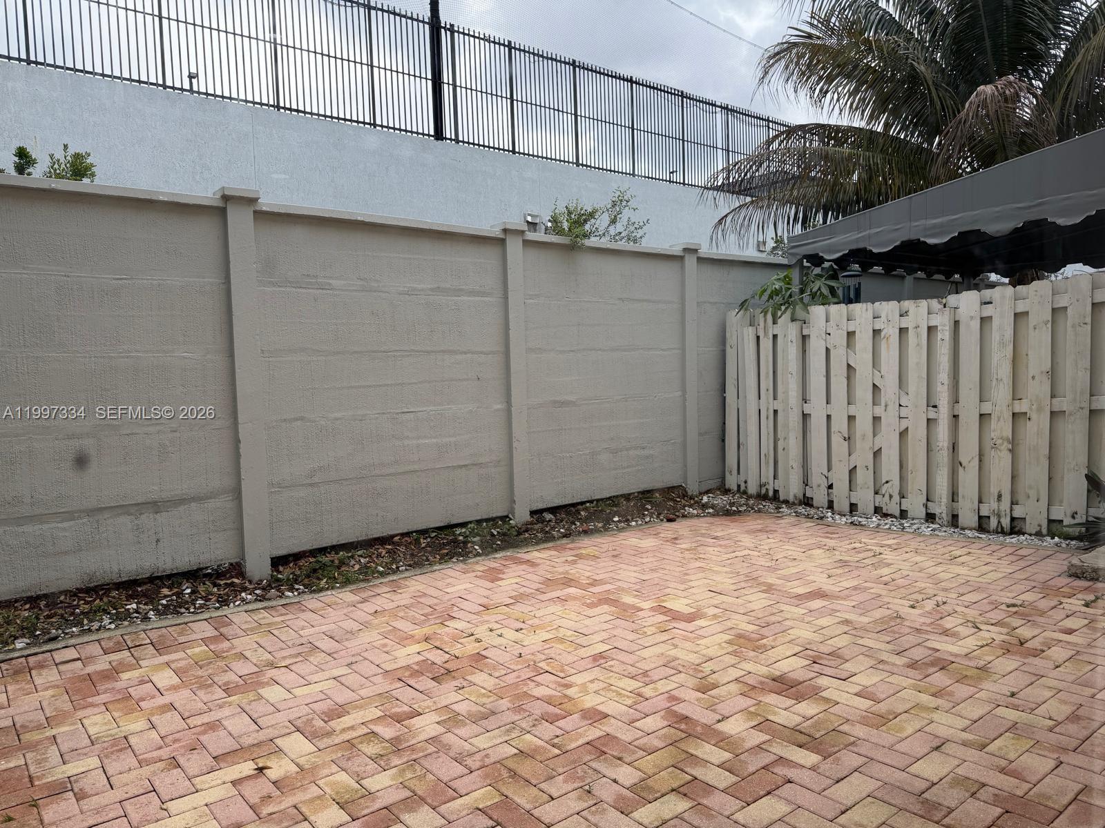 14934 Southwest 41st Lane, Unit 14934 Miami, FL 33185 - Photo 34 of 36 a view of a house with a wooden fence