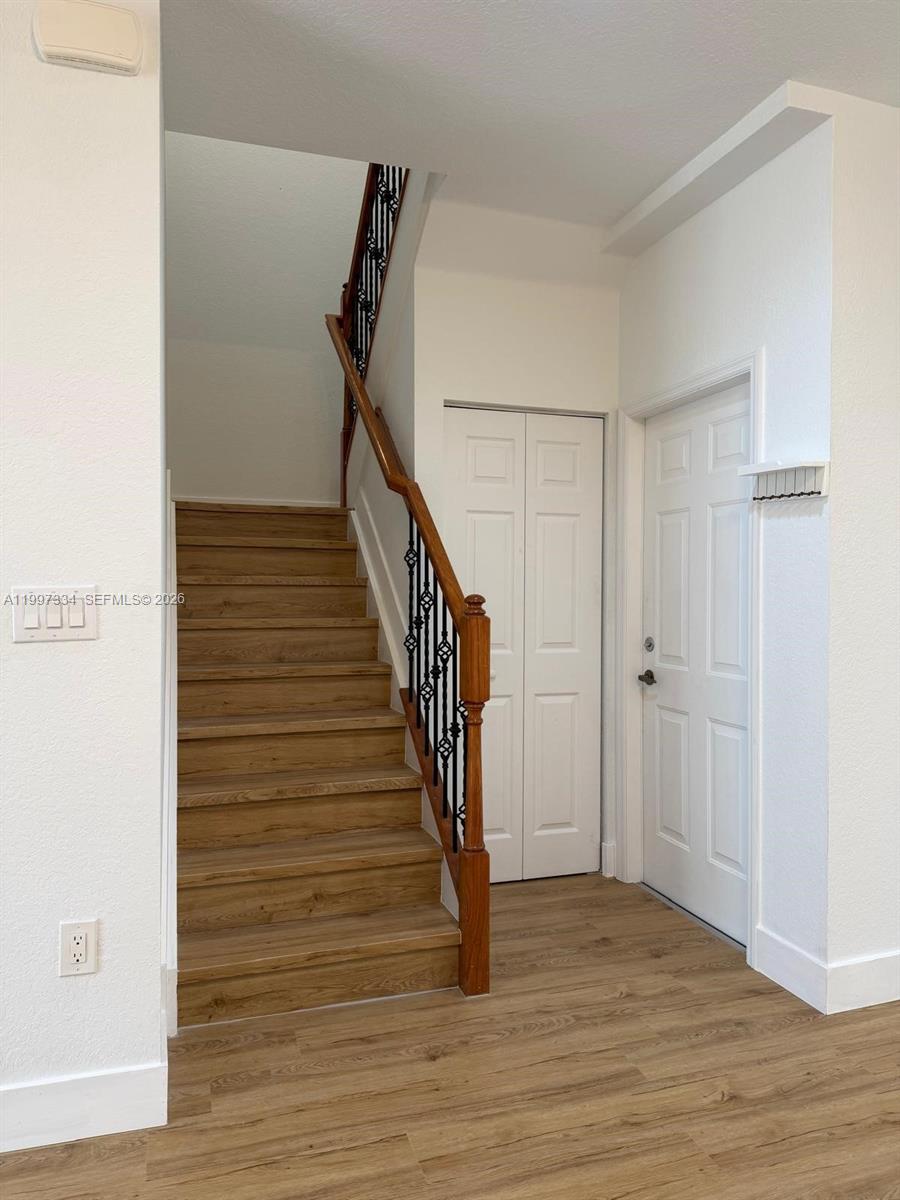 14934 Southwest 41st Lane, Unit 14934 Miami, FL 33185 - Photo 4 of 36 a view of a hallway with wooden floor and entryway