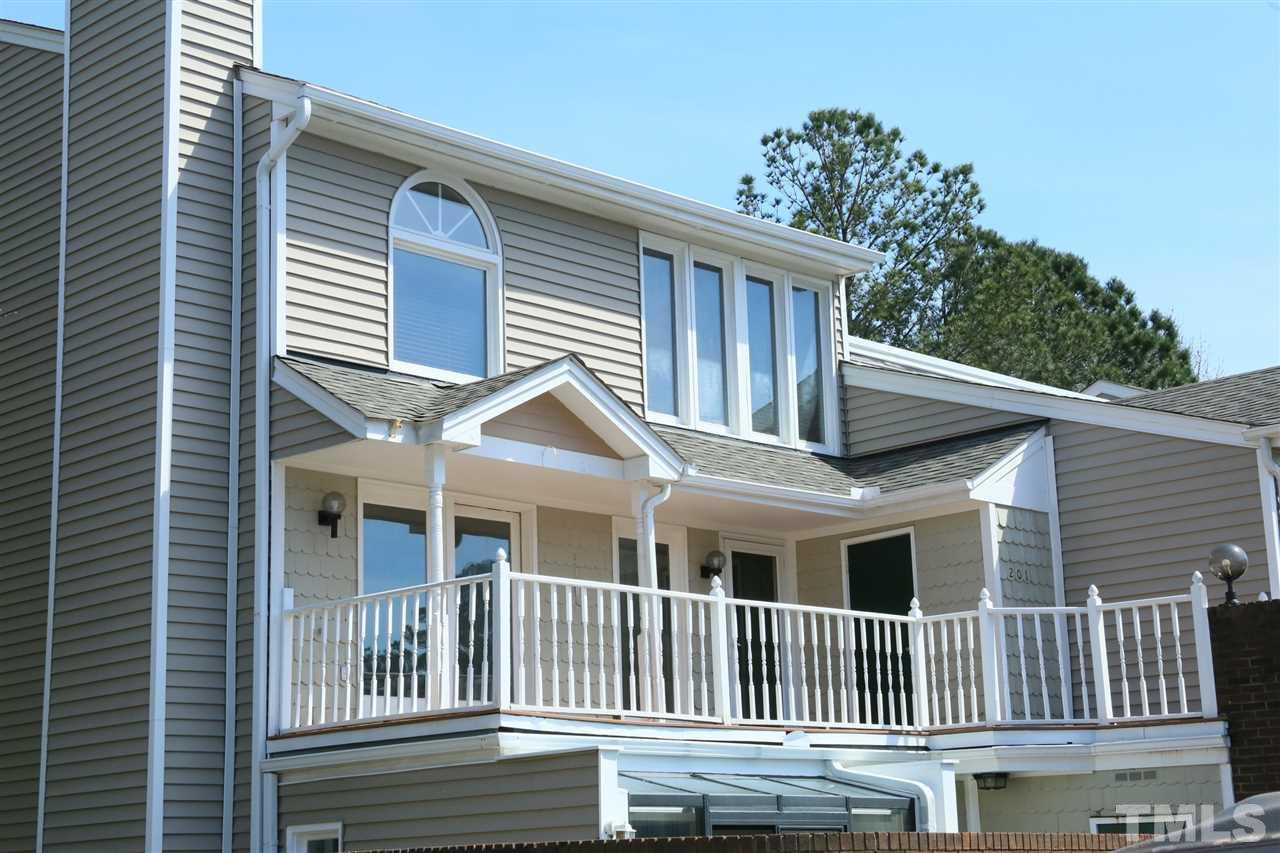 7040 Sandy Forks Road, Unit 201 Raleigh, NC 27615 - Photo 1 of 29 a front view of a house with a yard