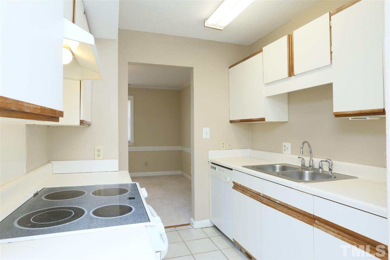 7040 Sandy Forks Road, Unit 201 Raleigh, NC 27615 - Photo 14 of 29 a kitchen with a sink stove and cabinets