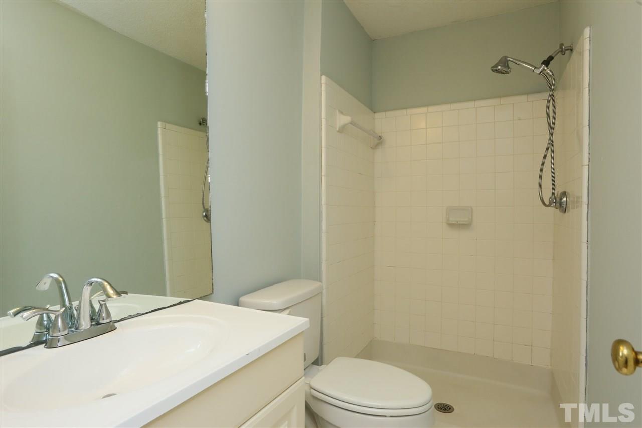 7040 Sandy Forks Road, Unit 201 Raleigh, NC 27615 - Photo 17 of 29 a bathroom with a sink toilet and shower