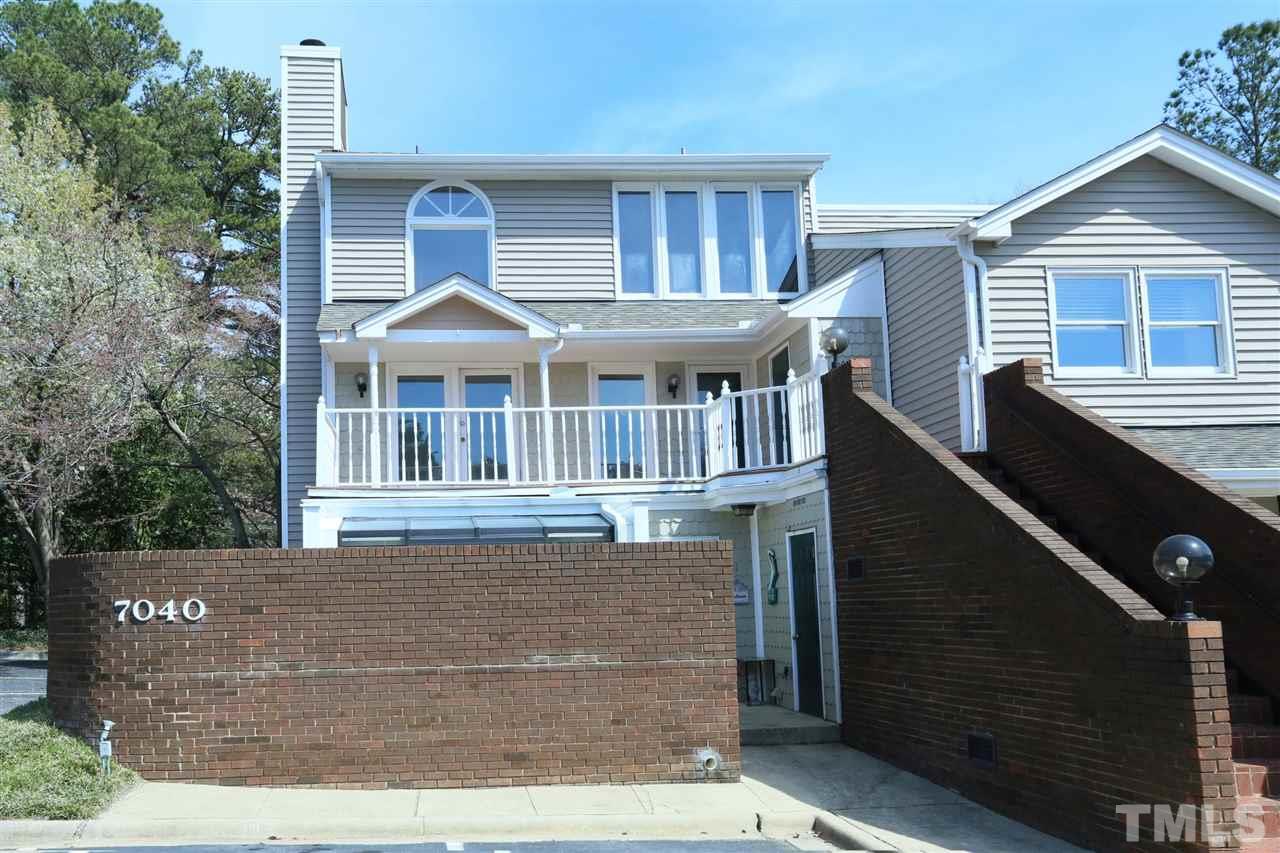 7040 Sandy Forks Road, Unit 201 Raleigh, NC 27615 - Photo 3 of 29 a front view of a house with a yard