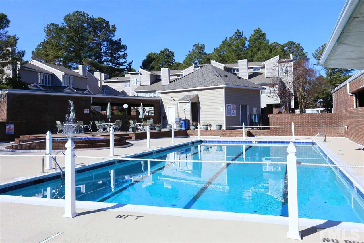 7040 Sandy Forks Road, Unit 201 Raleigh, NC 27615 - Photo 21 of 29 a view of a swimming pool with outdoor seating