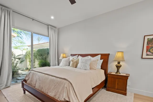 a bedroom with a large bed and a large window