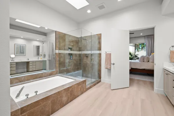 a spacious bathroom with a tub and shower