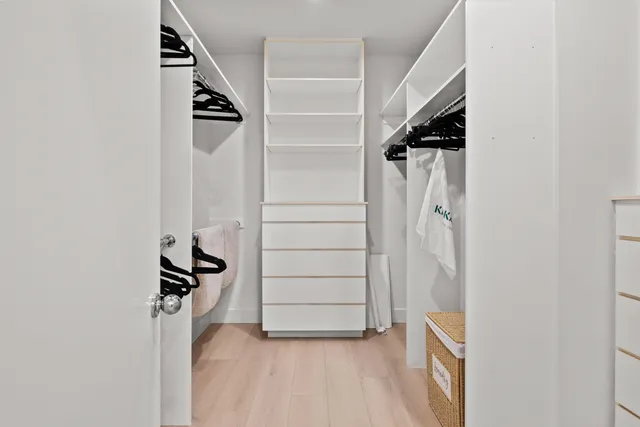 a bed sitting in a bedroom next to a window