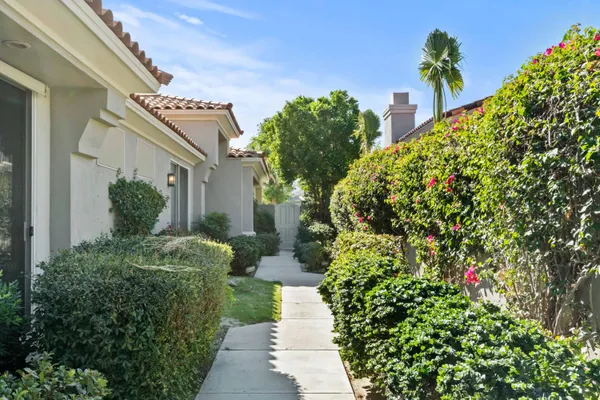 a view of a house with a flower garden