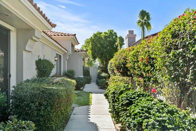 a view of a house with a flower garden