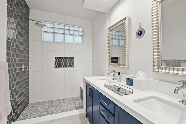 a bathroom with a double vanity sink and a mirror