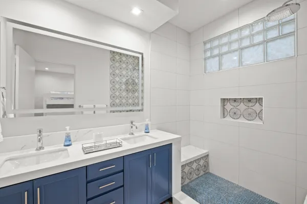 a view of a bedroom with wooden floor and windows