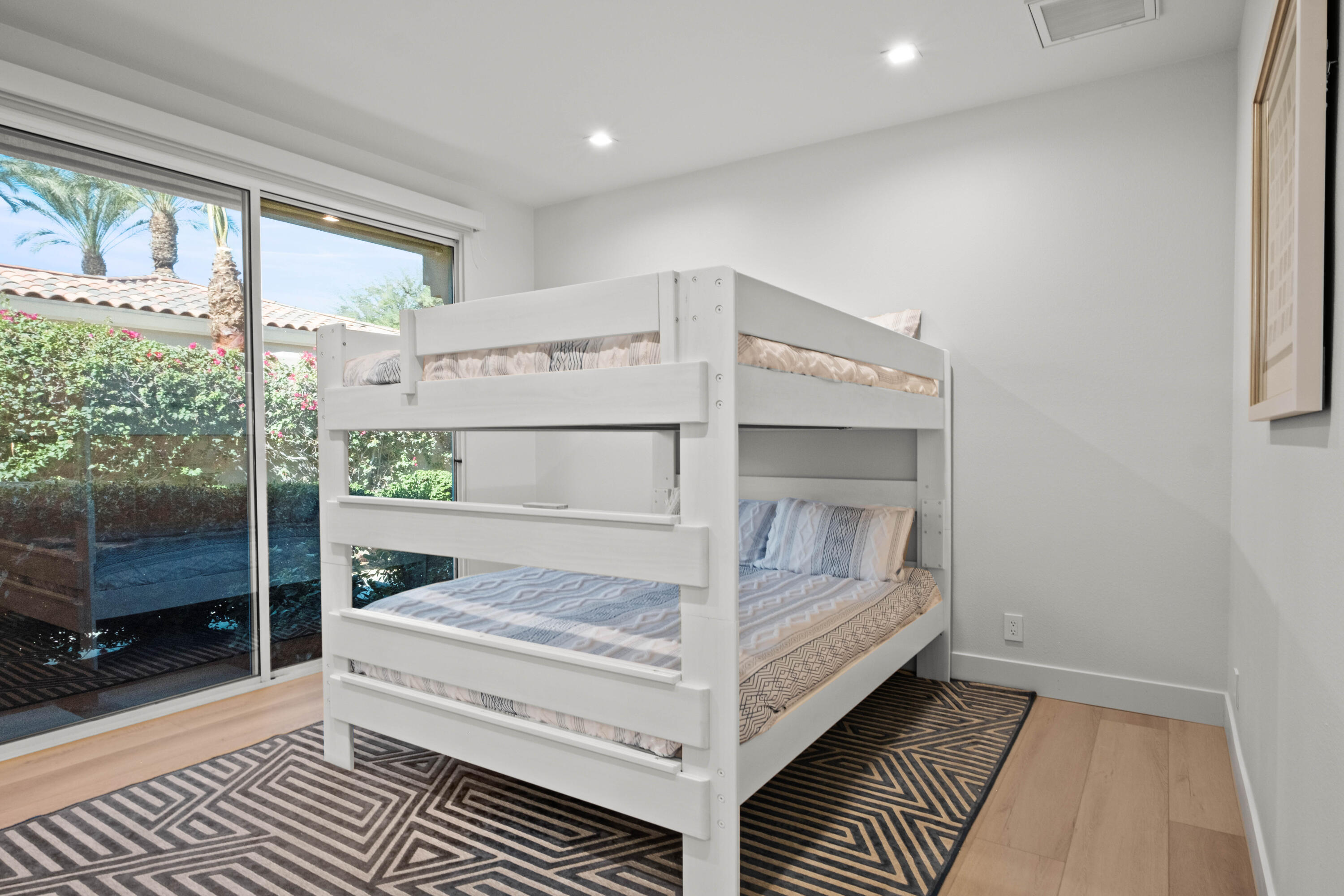 781 Box Canyon Trail Palm Desert, CA 92211 - Photo 24 of 31 a view of a bedroom with wooden floor and windows