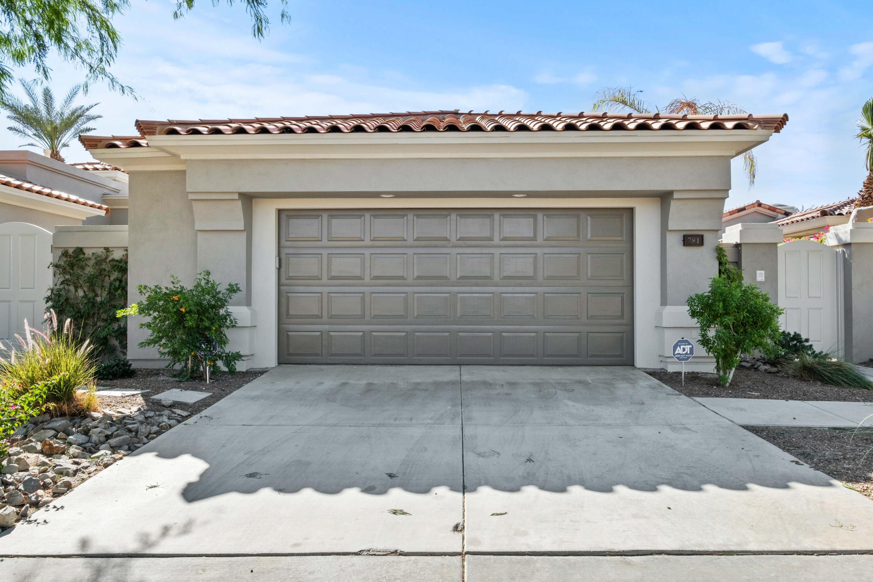 781 Box Canyon Trail Palm Desert, CA 92211 - Photo 27 of 31 a view of a house with a yard and a garage
