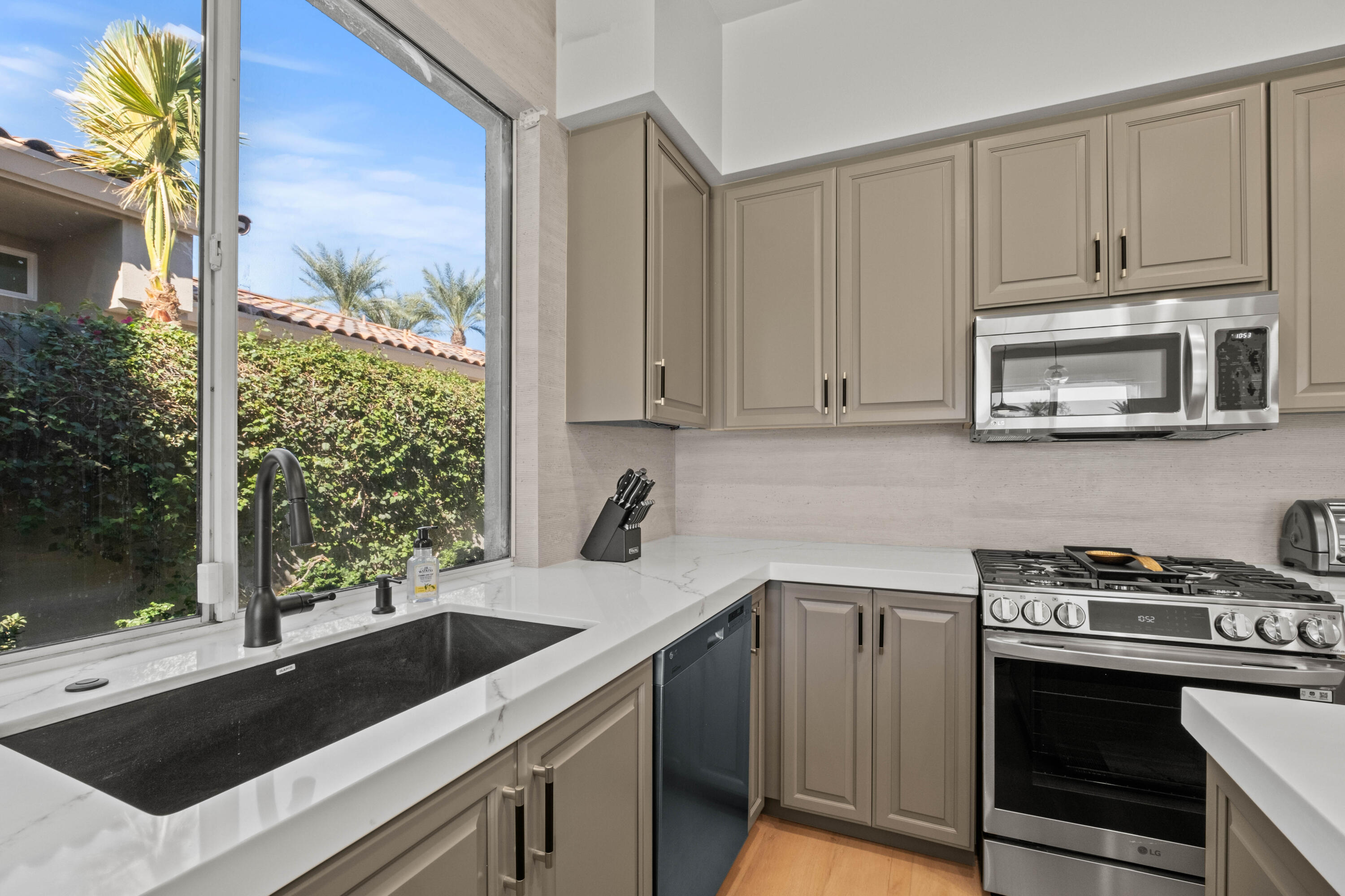 781 Box Canyon Trail Palm Desert, CA 92211 - Photo 7 of 31 a kitchen with a sink stove and microwave