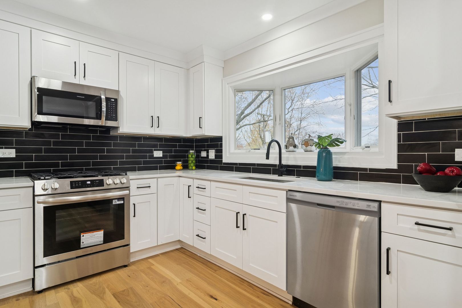 1420 Hassell Road Hoffman Estates, IL 60169 - Photo 12 of 26 a kitchen with cabinets stainless steel appliances a sink and a window