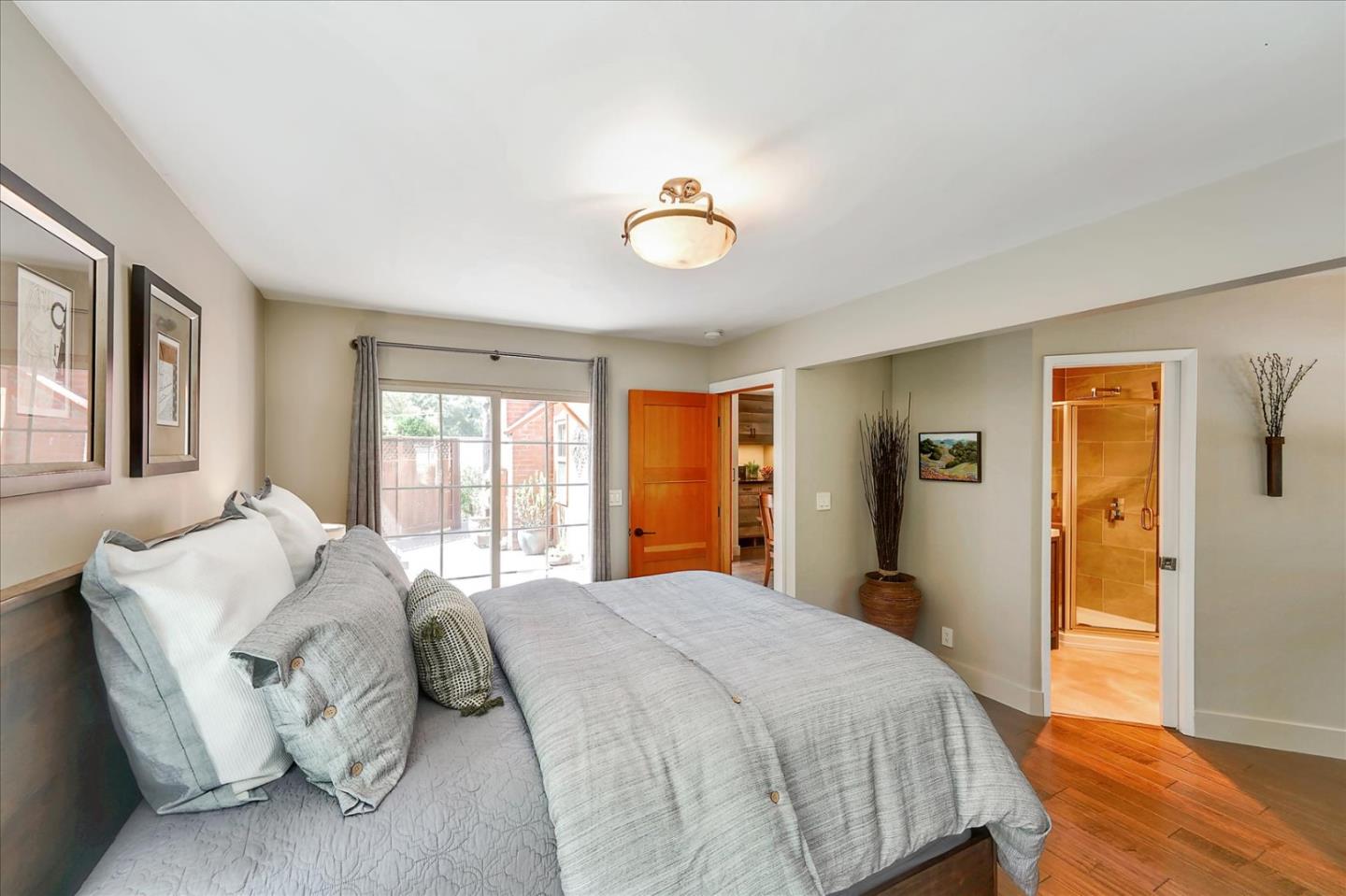 77 Forest Road Mount Hermon, CA 95041 - Photo 23 of 46 a spacious bedroom with a bed and wooden floor