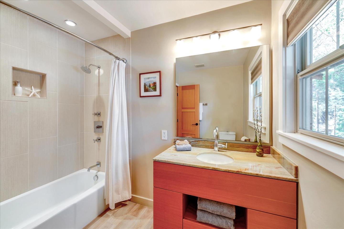 77 Forest Road Mount Hermon, CA 95041 - Photo 36 of 46 a bathroom with a double vanity sink and a bathtub