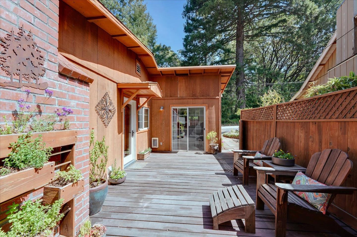 77 Forest Road Mount Hermon, CA 95041 - Photo 43 of 46 a view of a patio with table and chairs barbeque potted plants and large tree