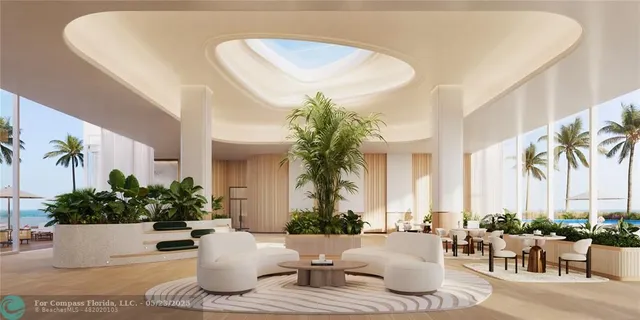 a living room with furniture and floor to ceiling windows