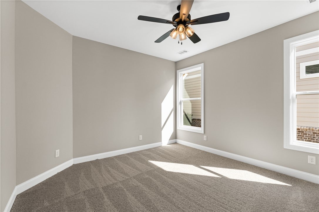 320 Coscoroba Road Auburn, AL 36832 - Photo 12 of 27 This airy room features abundant natural light and a practical ceiling fan for year-round comfort.