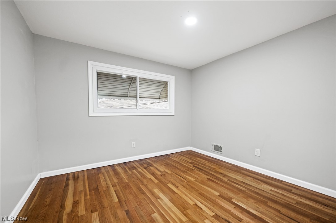 11417 Snow Road Parma Heights, OH 44130 - Photo 19 of 32 Unfurnished room with hardwood flooring