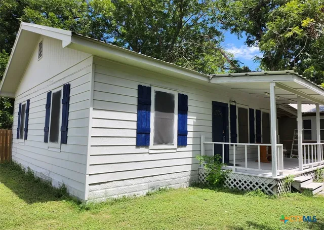 a view of a house with a small yard