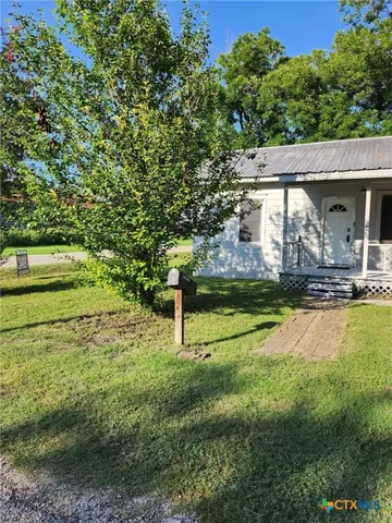 a view of a big yard with palm trees