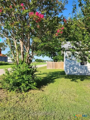a view of yard with swimming pool and green space
