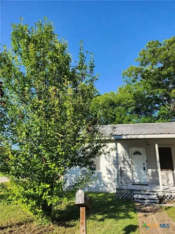 a view of a wooden house with a yard
