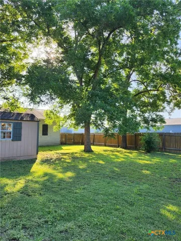 a swimming pool with outdoor seating and yard