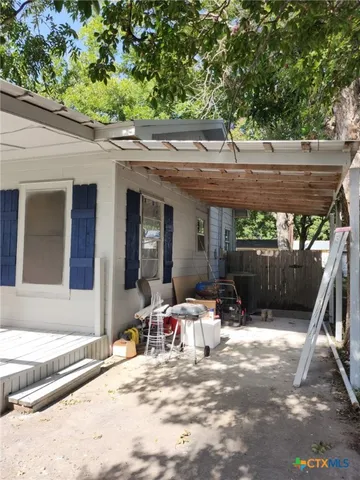 a view of a patio with a table and chairs