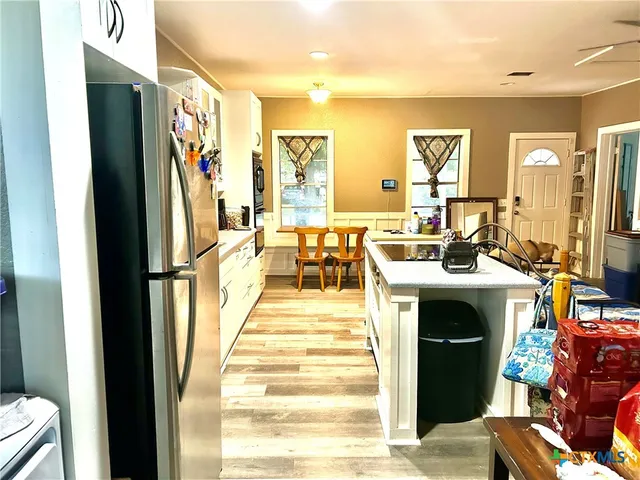a view of living room filled with furniture and a fireplace