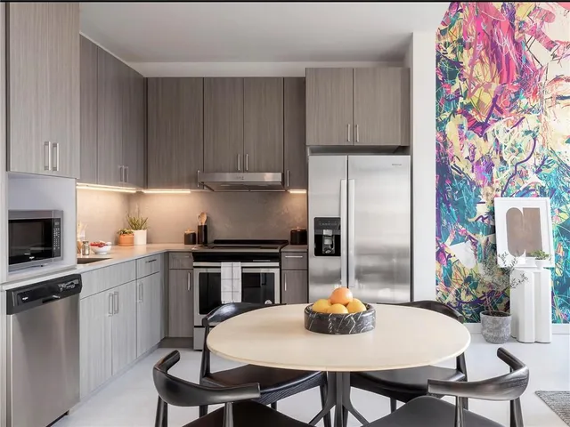 a kitchen with appliances cabinets a sink and a stove