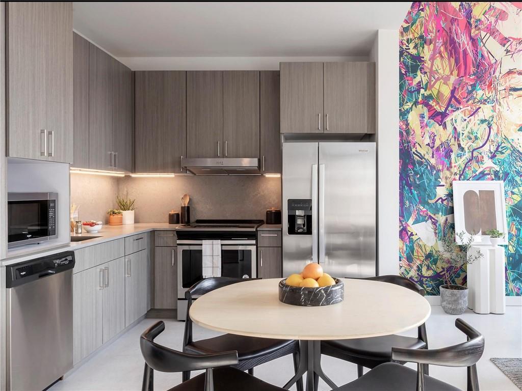 125 Ted Turner Drive Southwest, Unit 802 Atlanta, GA 30303 - Photo 2 of 21 a kitchen with appliances cabinets a sink and a stove
