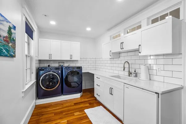a utility room with sink dryer and washer