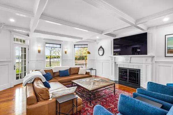 a living room with furniture fireplace and flat screen tv