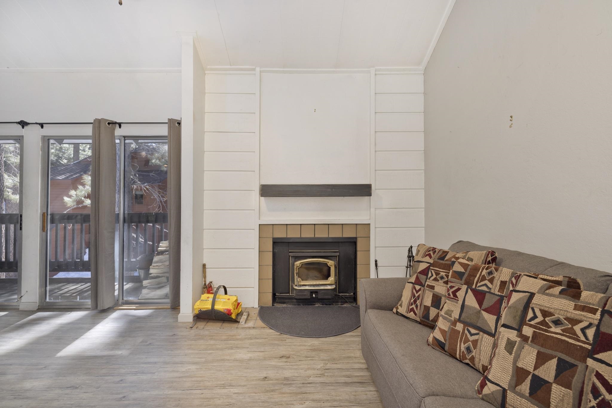2289 Sierra Nevada Road, Unit G10 Mammoth Lakes, CA 93546 - Photo 10 of 23 Living room featuring wood finished floors and a wood stove