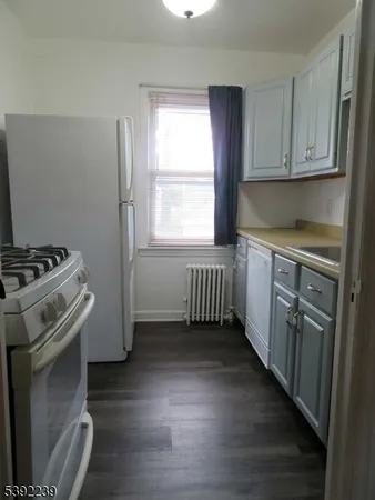 a kitchen with stainless steel appliances a stove a sink and a window